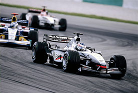 Kimi Raikkonen, McLaren; leads Nick Heidfeld, Sauber; and Jenson Button, BAR