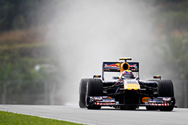Mark Webber grabbed pole for Red Bull as the rain hit Sepang during qualifying