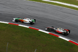Adrian Sutil leads Lewis Hamilton at Sepang