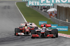 Jenson Button races Felipe Massa in Malaysia