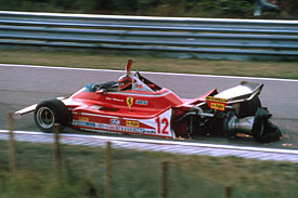 Gilles Villeneuve drags his damaged Ferrari back to the pits