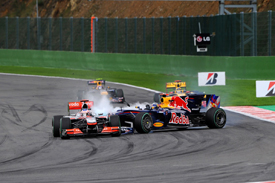Sebastian Vettel crashes into Jenson Button at Spa
