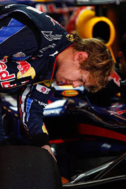 Sebastian Vettel looks at the Pirelli tyres