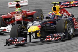 Mark Webber's Red Bull races with Felipe Massa's Ferrari at Sepang