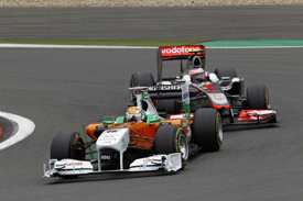 Adrian Sutil leads Jenson Button in Germany