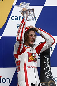 Marco Simoncelli celebrates his first MotoGP podium