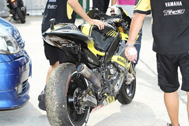 Colin Edwards' Tech 3 Yamaha is brought back to the pits after the crash that killed Marco Simoncelli at Sepang