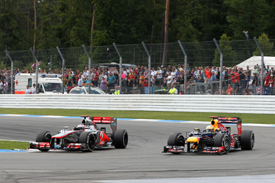 Jenson Button races with Sebastian Vettel at Hockenheim