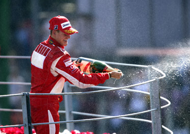 Schumacher celebrates on the Monza podium shortly before announcing his retirement