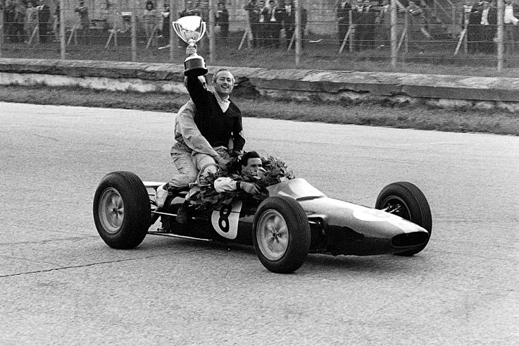 Colin Chapman hitches a ride on his world championship-winning Lotus